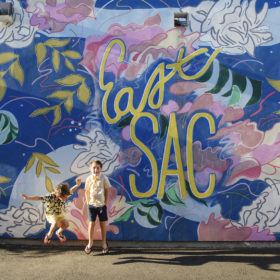 boys laughing in front of mural in east sacramento california