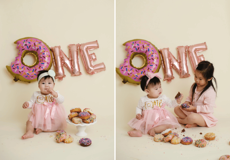 one year old birthday cake smash studio photo shoot baby girl tasting donuts