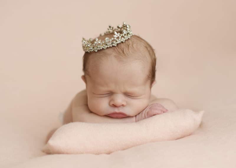 newborn baby girl wearing a tiara studio photo shoot pink