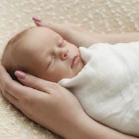 newborn baby girl sleeping in a studio photo shoot