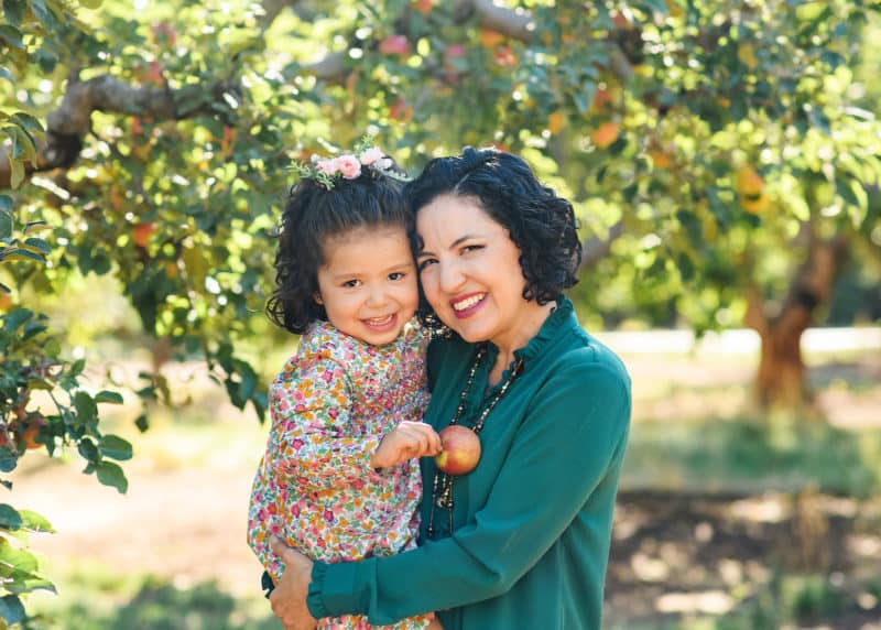 mom and daughter family photos in the apple orchard in sacramento california