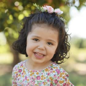 young girl in fall family photos in apple orchard sacramento california