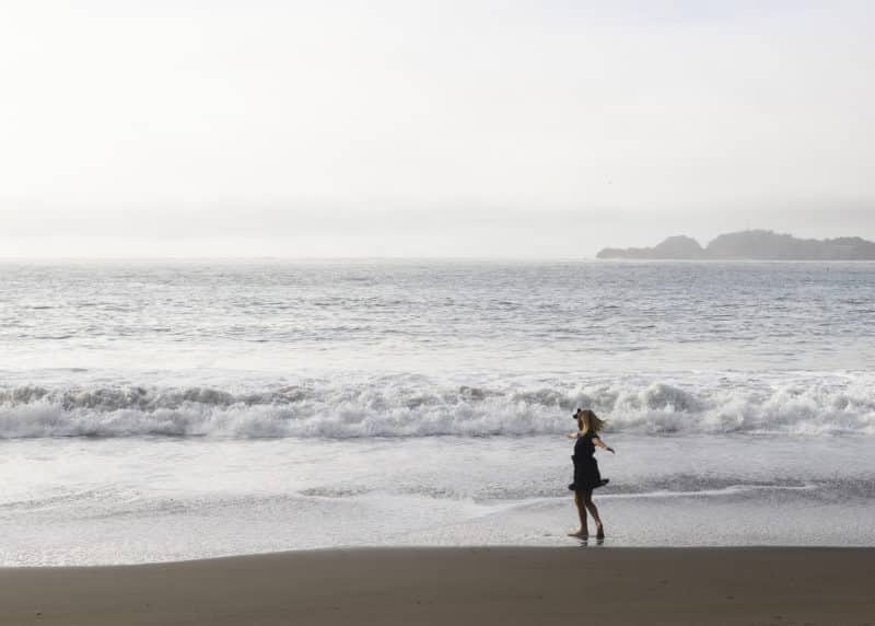 young girl twirling in the ocean waves san francisco california