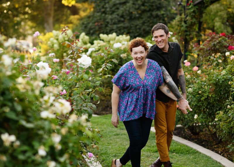 couple laughing and walking in the rose garden sacramento california