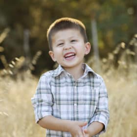 young boy smiling in the field sacramento california gibson ranch