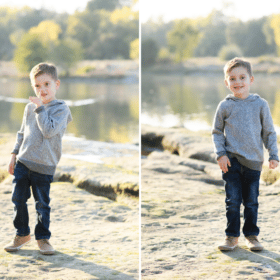 young boy picking nose, smiling in front of the river