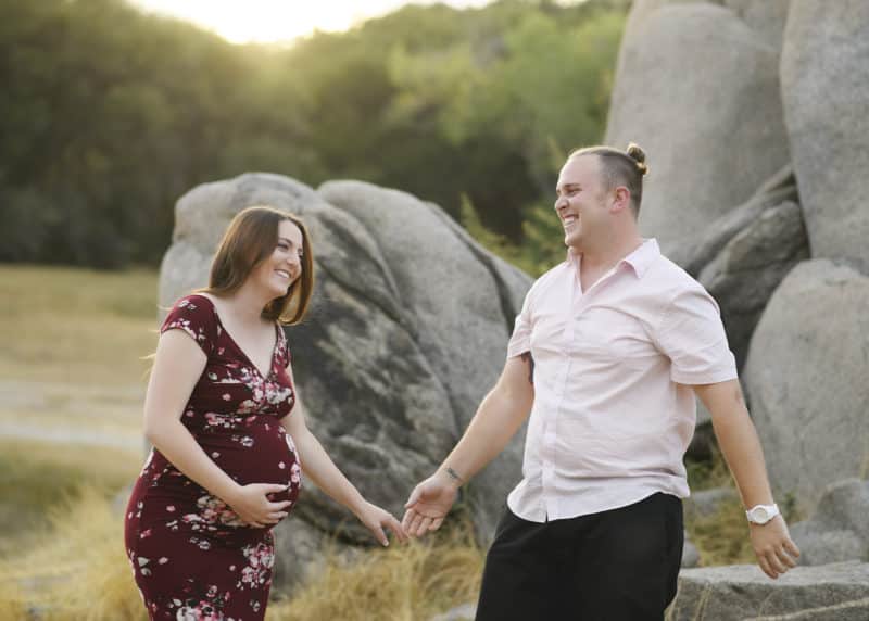 couple laughing during maternity photo shoot in granite bay california