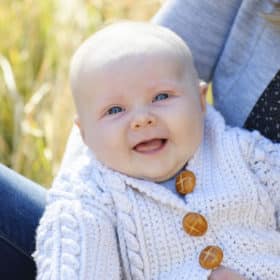 baby boy smiling outside fall family photos