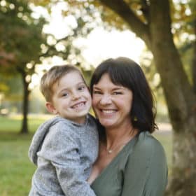 mom and young son smiling in the sunset fall photos