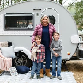 mom with young sons in front of family camper