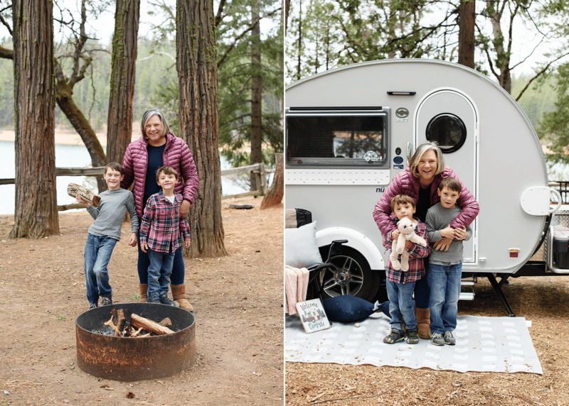 mom and sons standing by campfire, camper in the woods