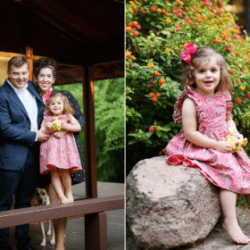 family of three posing on the porch, young daughter in front of flowers