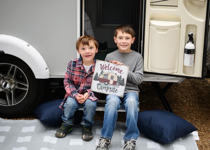 two brothers posing in front of family camper