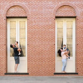 family of four smiling in front of a brick building in old town sacramento california