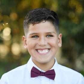 young boy smiling at the camera during family photo shoot elk grove california