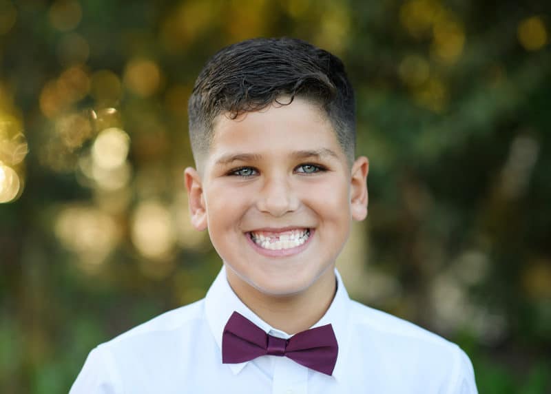 young boy smiling at the camera during family photo shoot elk grove california