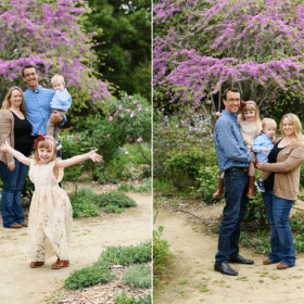 mom and dad with two young kids posing together in spring