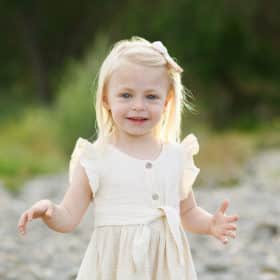 toddler girl posing by the river in yellow dress fair oaks california