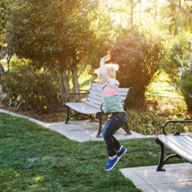 boy jumping off of bench in the spring garden sacramento california