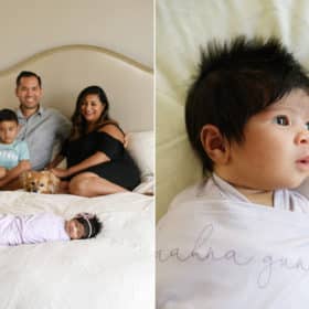family of four sitting on bed with newborn baby girl wrapped in name blanket