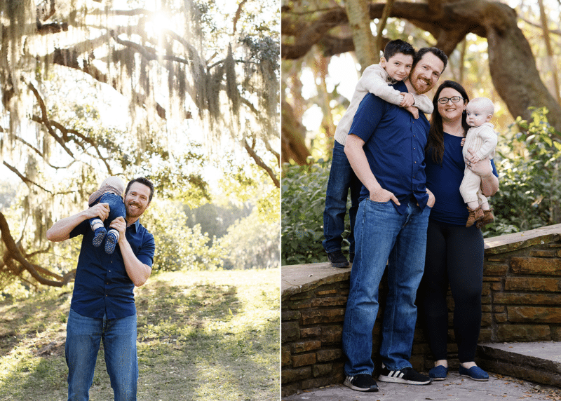 family of four posing along stone wall outdoors, dad carrying baby on his shoulder