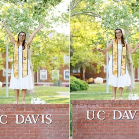 college graduate dancing on brick UC Davis sign
