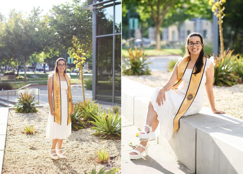college graduate posing in a white dress with graduation stole at UC Davis