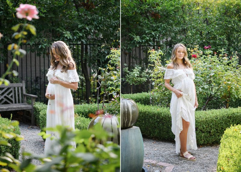 pregnant woman holding belly in the garden in a white flowy dress