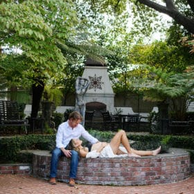 maternity session in the garden in sacramento california laying by the fountain