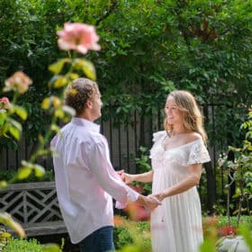couple holding hands in the garden during home maternity session sacramento california