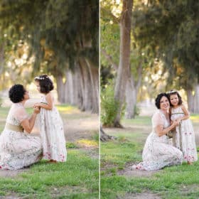 mom and daughter holding hands and hugging in a tree-lined path in sacramento california