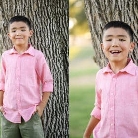 young boy posing in a pink shirt by a tree during family photo session in sacramento california