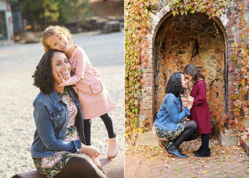 mom with young daughter on the beach, nose kisses in front of the fall foliage