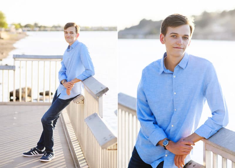 high school senior boy wearing blue button up during senior photo session on folsom lake california