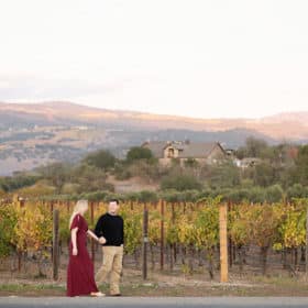 taking family photos in the napa valley with a vineyard in the background