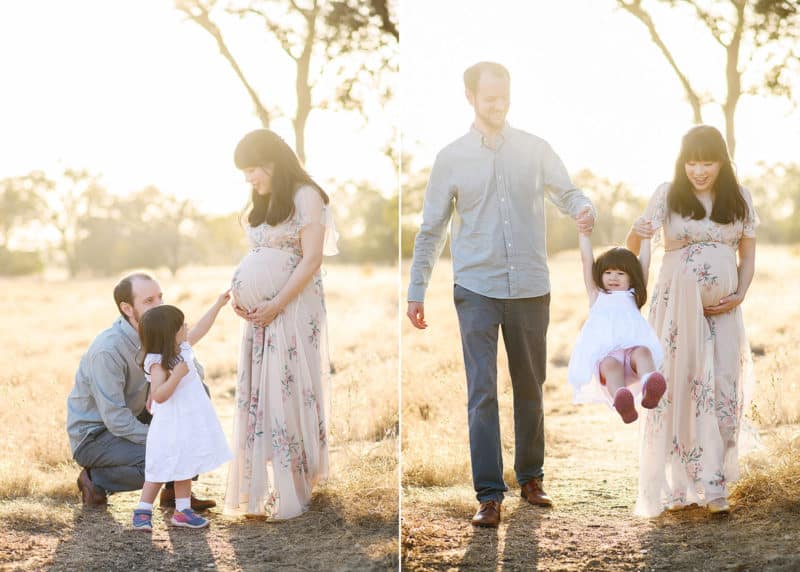 mom and dad with young girl taking maternity photos in the golden light