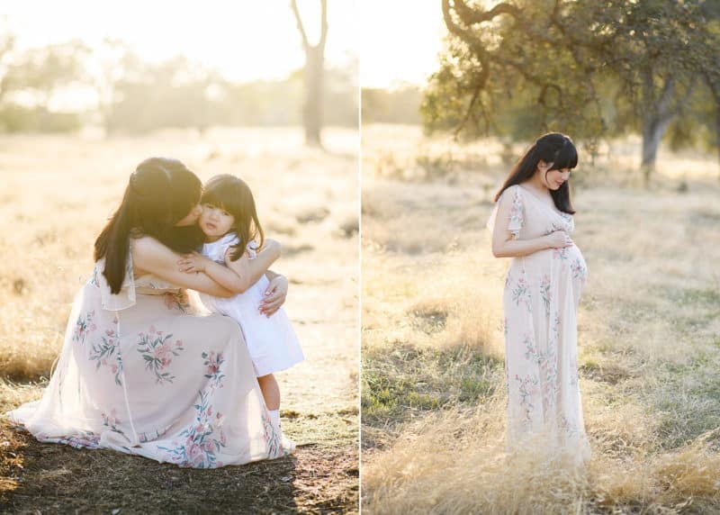 mom hugging young daughter during maternity photos, holding belly in the sunset