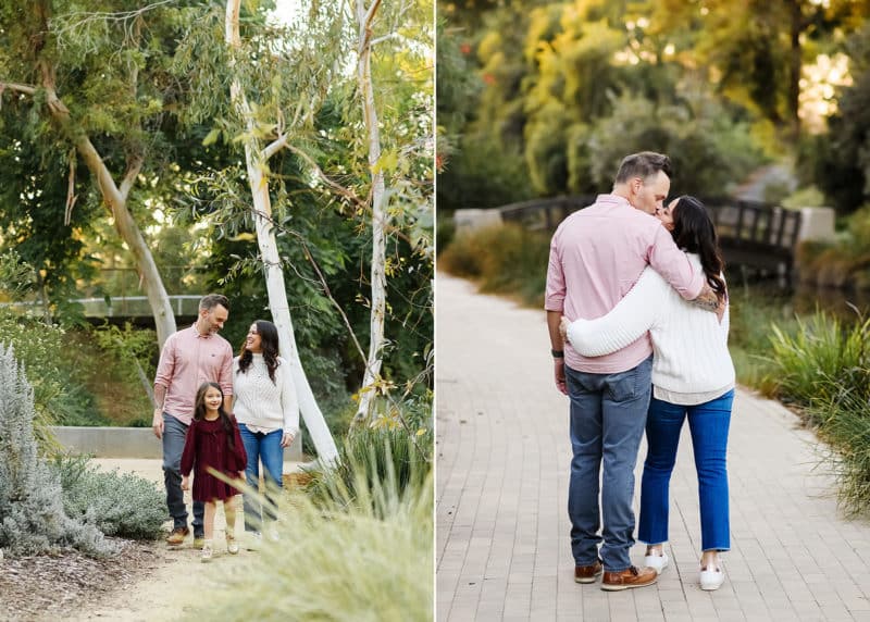 mom and dad walking along a path hugging and kissing, family of three walking forward during family photos