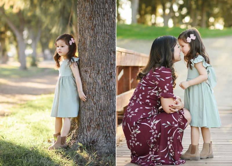 young girl standing by the tree, mom and daughter touching foreheads during family session in sacramento california