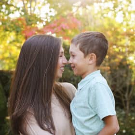mom and son touching noses in front of autumn leaves fall family photos berkeley california
