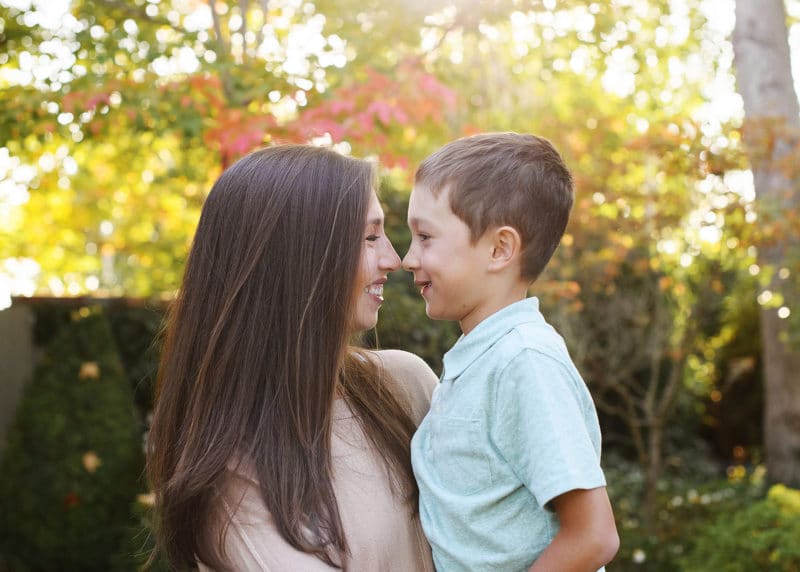 mom and son touching noses in front of autumn leaves fall family photos berkeley california