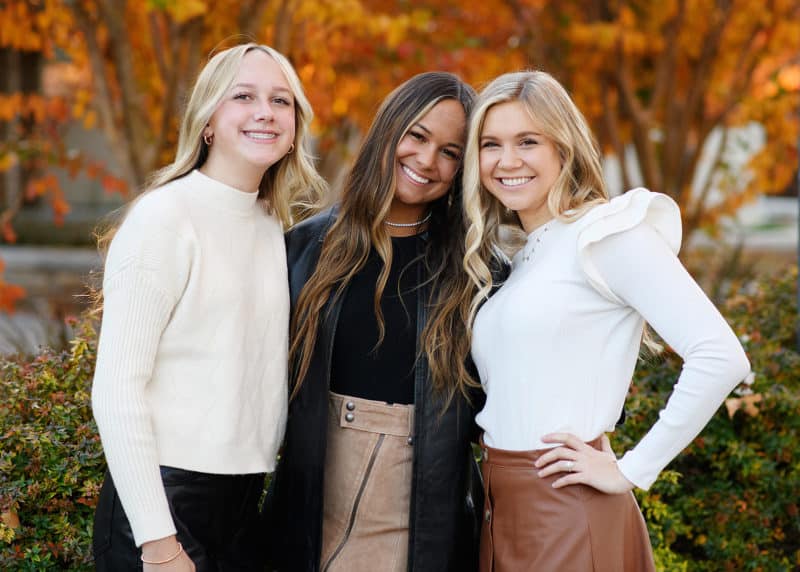 sisters standing together in the fall colors during family photos in el dorado hills california