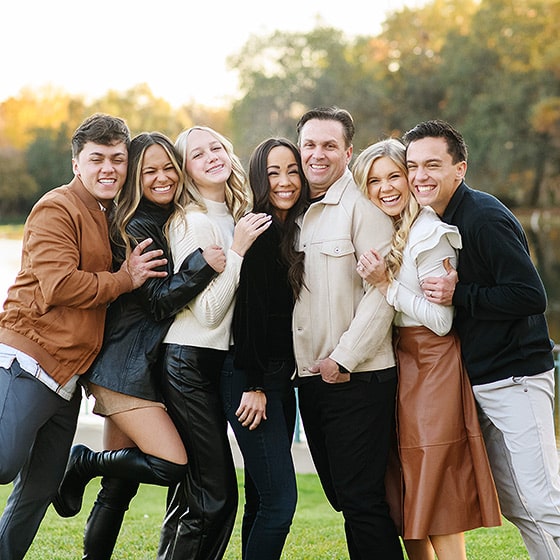 extended family squishing together laughing during fall family photos in el dorado hills california