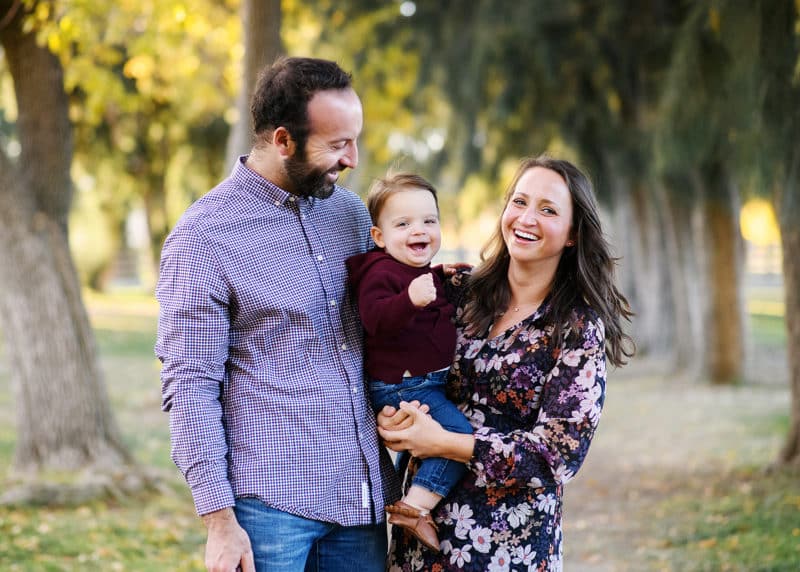 mom and dad holding baby boy during fall family photo shoot