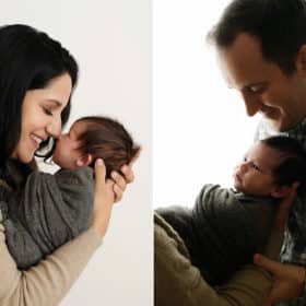 mom touching newborn son nose to nose, dad holding baby in studio photo session