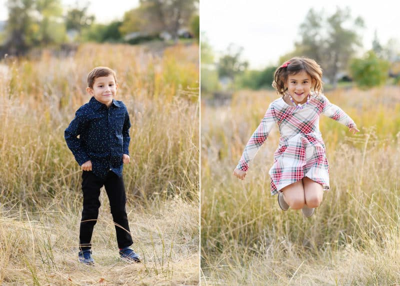 young boy standing in a field during family photos, young girl jumping in a holiday dress