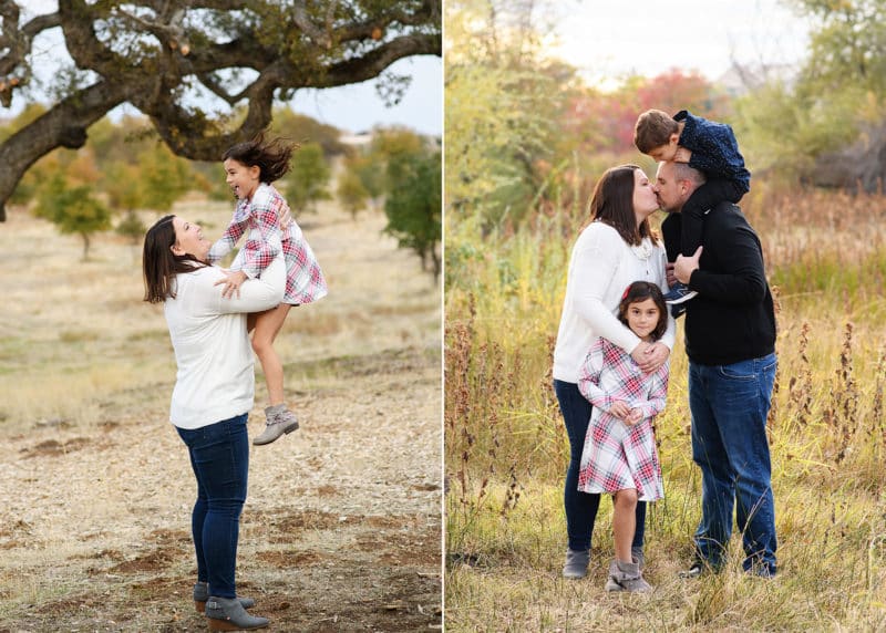 mom holding young daughter in the air, mom and dad kissing with kids looking on during family photos