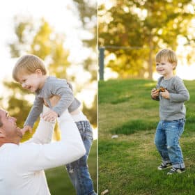 young boy standing in a field of grass laughing, dad holding son in the air during family photos