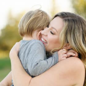 mom hugging young son during family photos in sacramento california