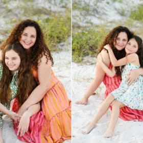 mom with two young daughters sitting on the beach in Florida taking vacation photos